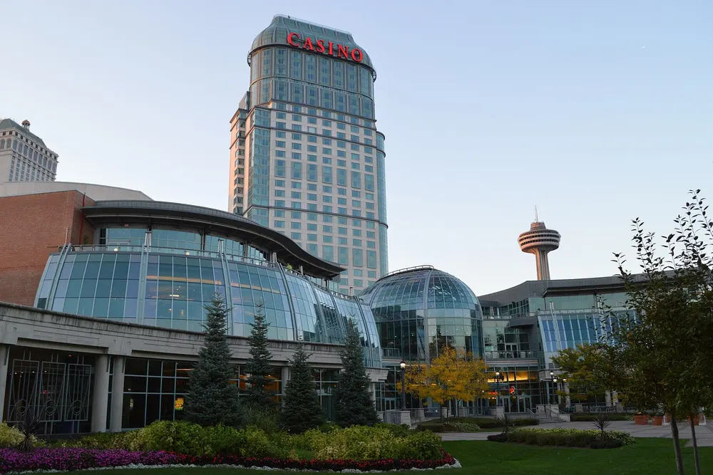 Fallsview Casino Resort by day: the glass-domed casino front and gardens below the hotel tower